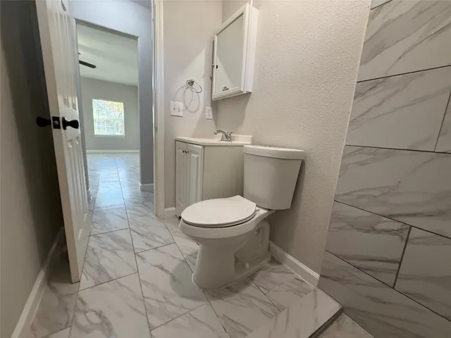 a bathroom with a toilet and a shower