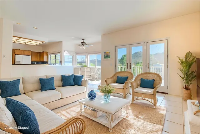 a spacious bedroom with a large bed couch and a large window