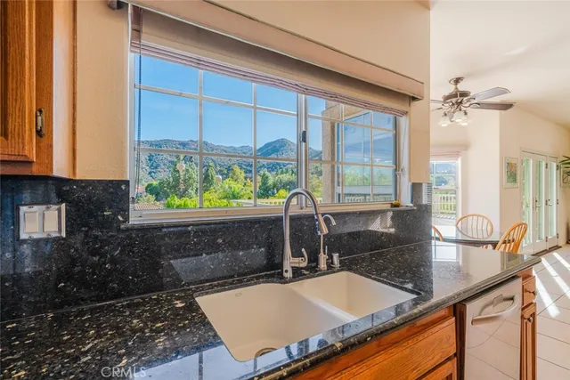 a living room with furniture a fireplace and a potted plant