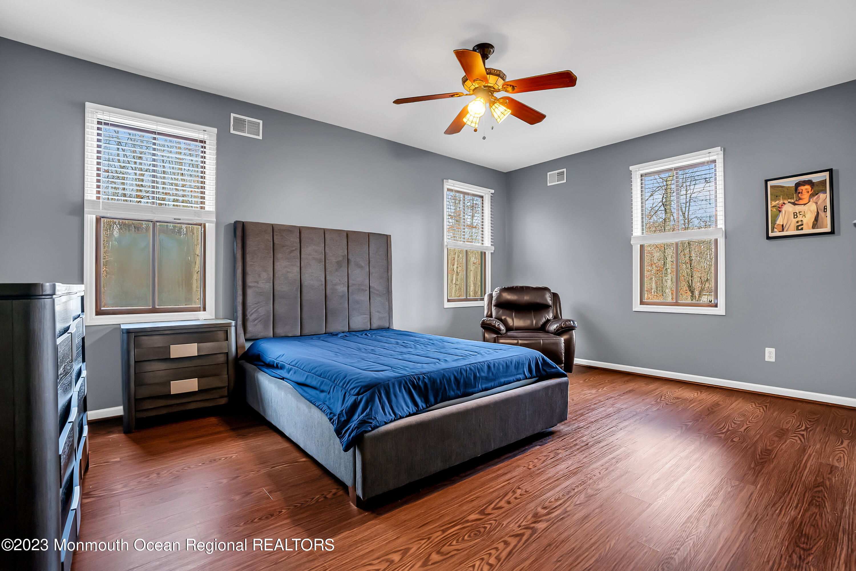13 Pine Drive Millstone Township, NJ 08510 - Photo 36 of 56 a bedroom with a bed and a chandelier