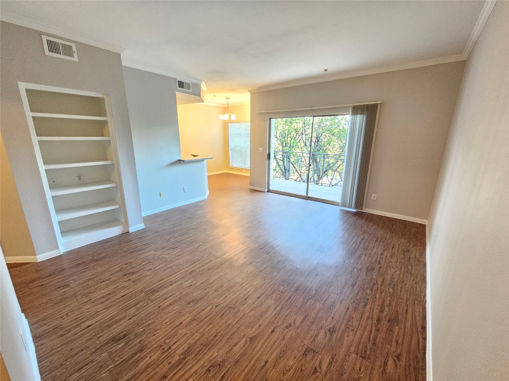 6000 Shepherd Mountain Cove, Unit 1908 Austin, TX 78730 - Photo 2 of 24 a view of an empty room with a window and wooden floor