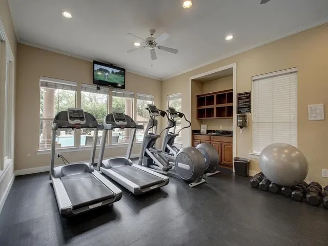 a room with gym equipment and a large window