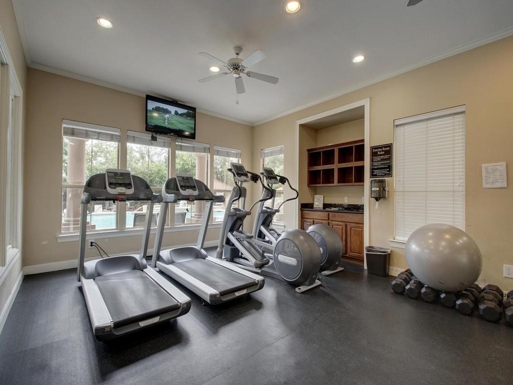 6000 Shepherd Mountain Cove, Unit 1908 Austin, TX 78730 - Photo 23 of 24 a room with gym equipment and a large window