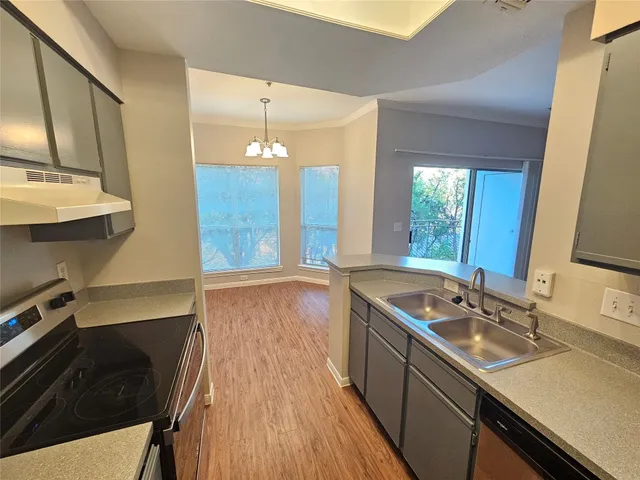 a kitchen with a sink stove and cabinets