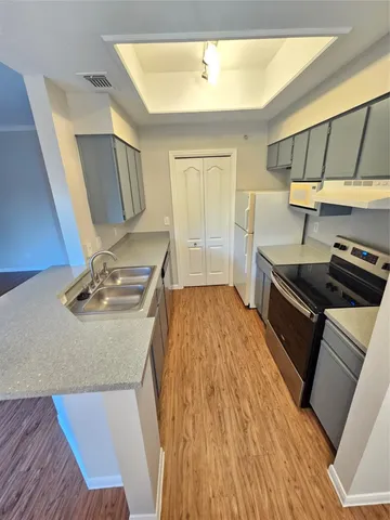 a kitchen with a sink appliances and cabinets