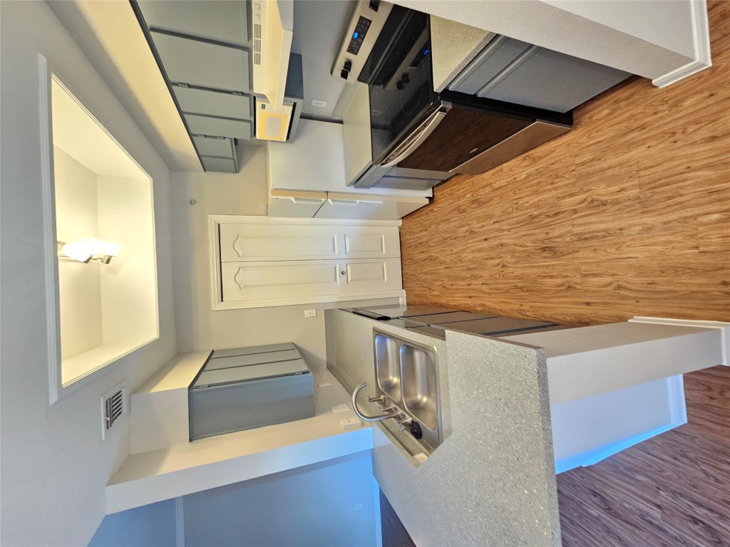 6000 Shepherd Mountain Cove, Unit 1908 Austin, TX 78730 - Photo 8 of 24 a kitchen with a sink appliances and cabinets