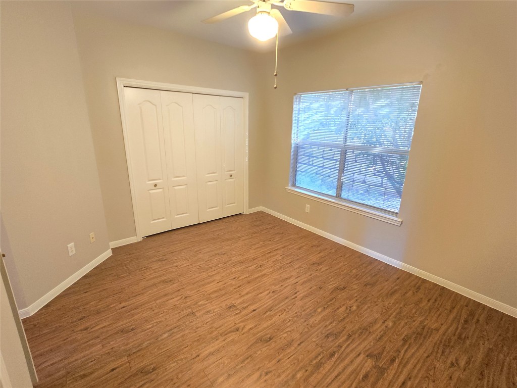 6000 Shepherd Mountain Cove, Unit 1908 Austin, TX 78730 - Photo 10 of 24 a view of an empty room with wooden floor and a window