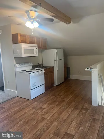 a kitchen with a stove and a refrigerator