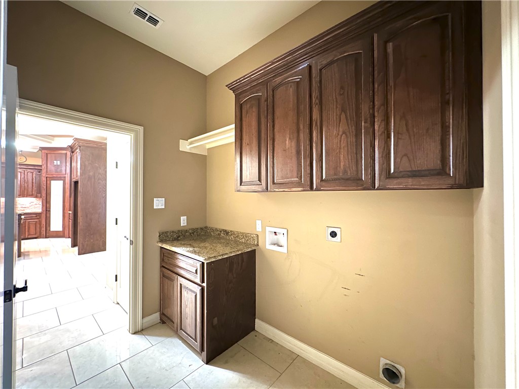 1503 Lewis Street Kingsville, TX 78363 - Photo 11 of 30 a bathroom with a granite countertop sink and a mirror
