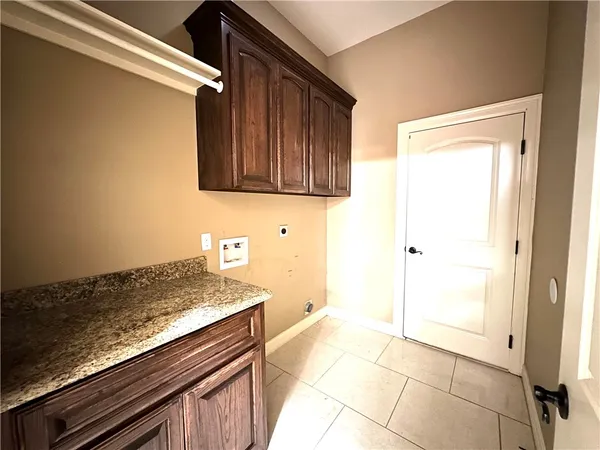 a view of kitchen with granite countertop cabinets and black appliances