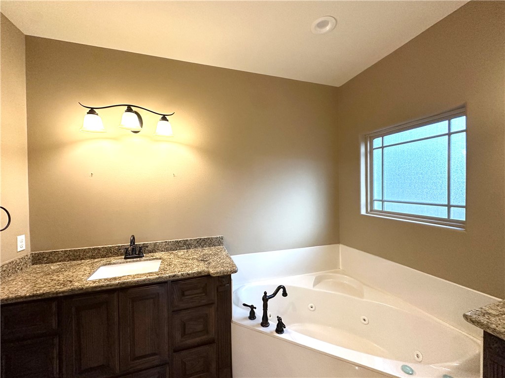 1503 Lewis Street Kingsville, TX 78363 - Photo 18 of 30 a bathroom with a tub sink and mirror