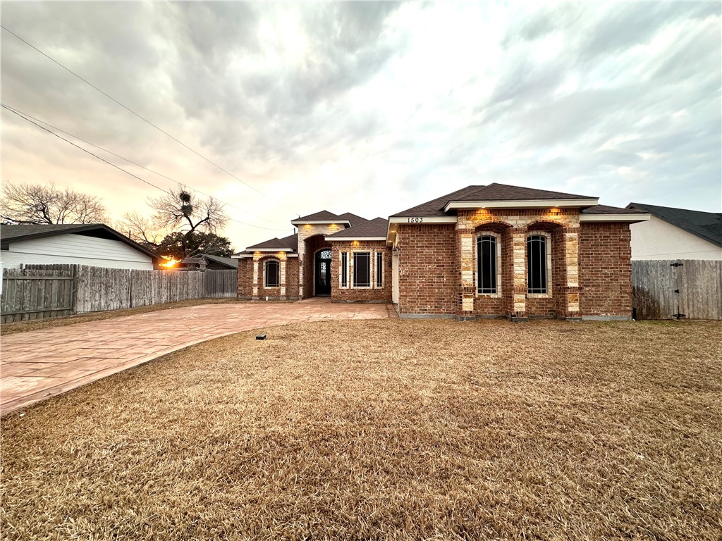 1503 Lewis Street Kingsville, TX 78363 - Photo 2 of 30 a front view of a house with a garden