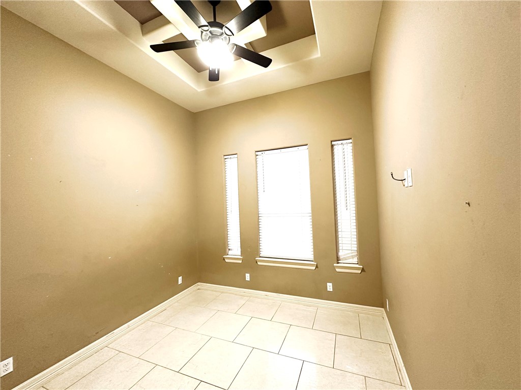 1503 Lewis Street Kingsville, TX 78363 - Photo 22 of 30 a view of an empty room and window with a fan