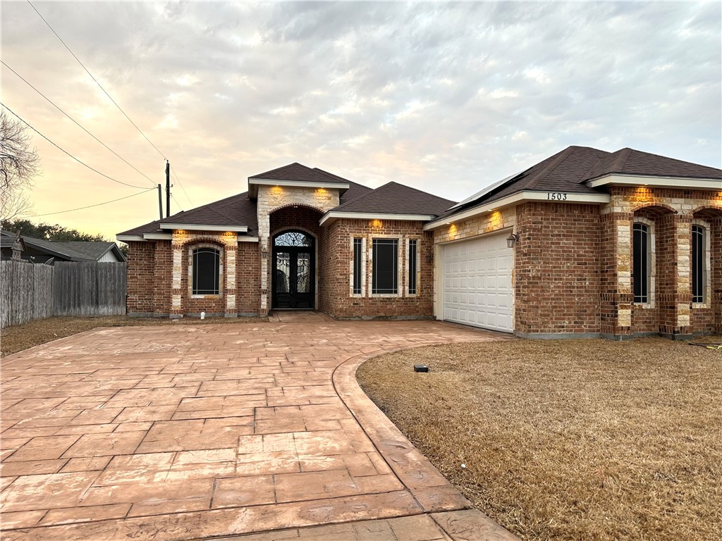 1503 Lewis Street Kingsville, TX 78363 - Photo 3 of 30 a front view of a house with a yard