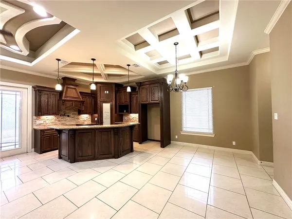 a kitchen with stainless steel appliances kitchen island granite countertop a refrigerator and a sink