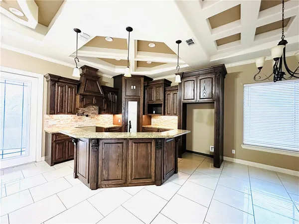 a kitchen with stainless steel appliances kitchen island granite countertop a sink and cabinets