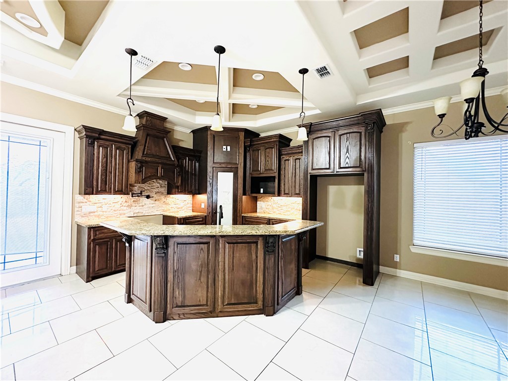 1503 Lewis Street Kingsville, TX 78363 - Photo 10 of 30 a kitchen with stainless steel appliances kitchen island granite countertop a sink and cabinets