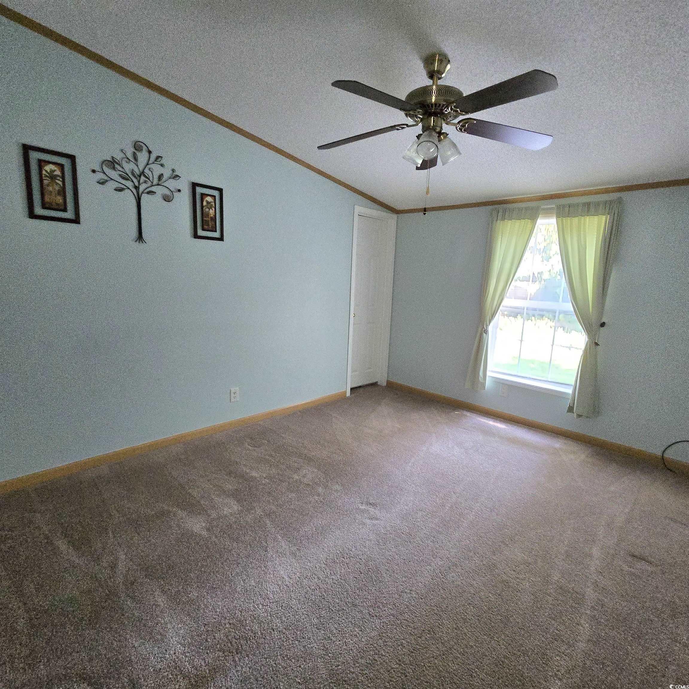34 Talon Circle Murrells Inlet, SC 29576 - Photo 12 of 40 Empty room with crown molding, a textured ceiling, a ceiling fan, and carpet