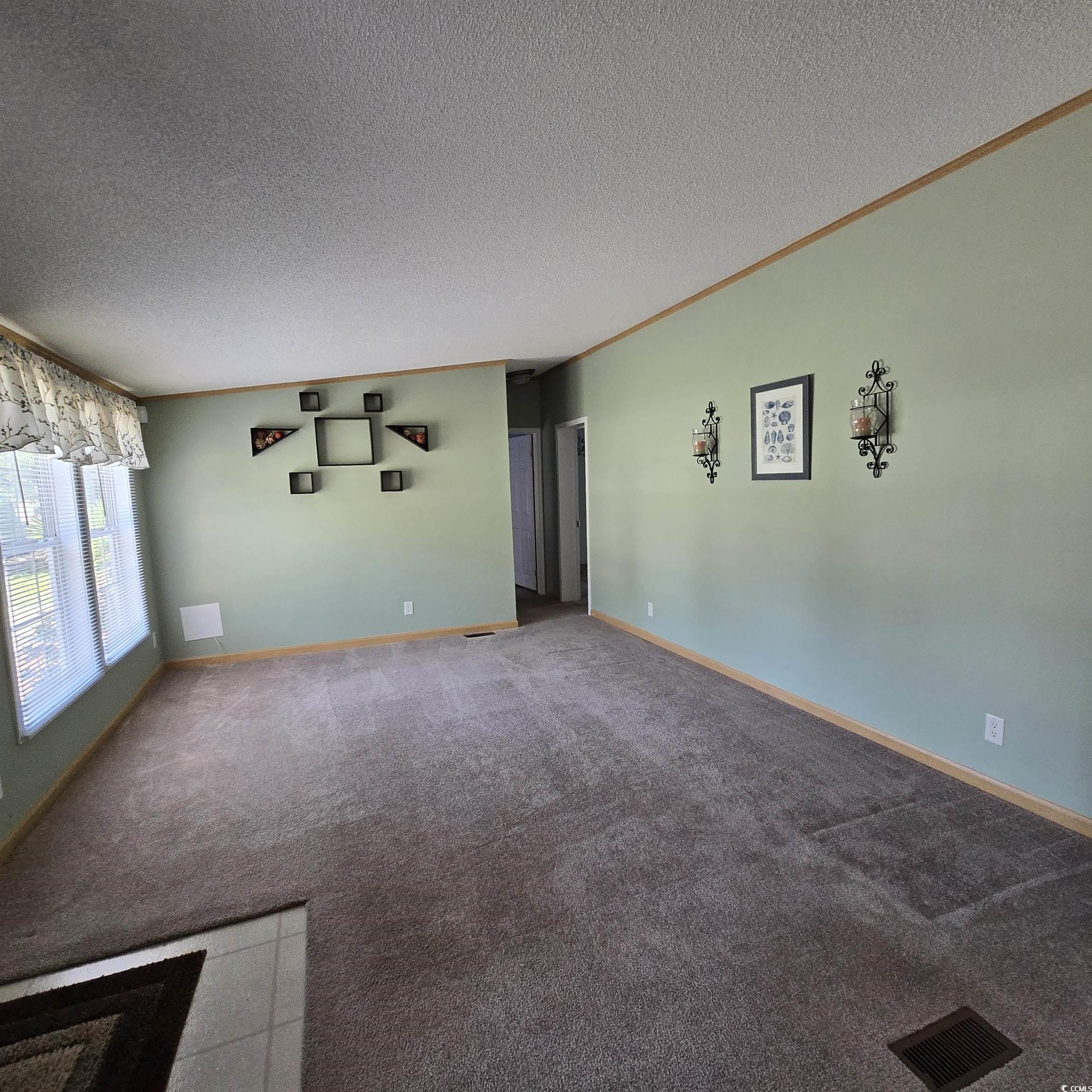 34 Talon Circle Murrells Inlet, SC 29576 - Photo 13 of 40 Carpeted empty room featuring a textured ceiling and ornamental molding