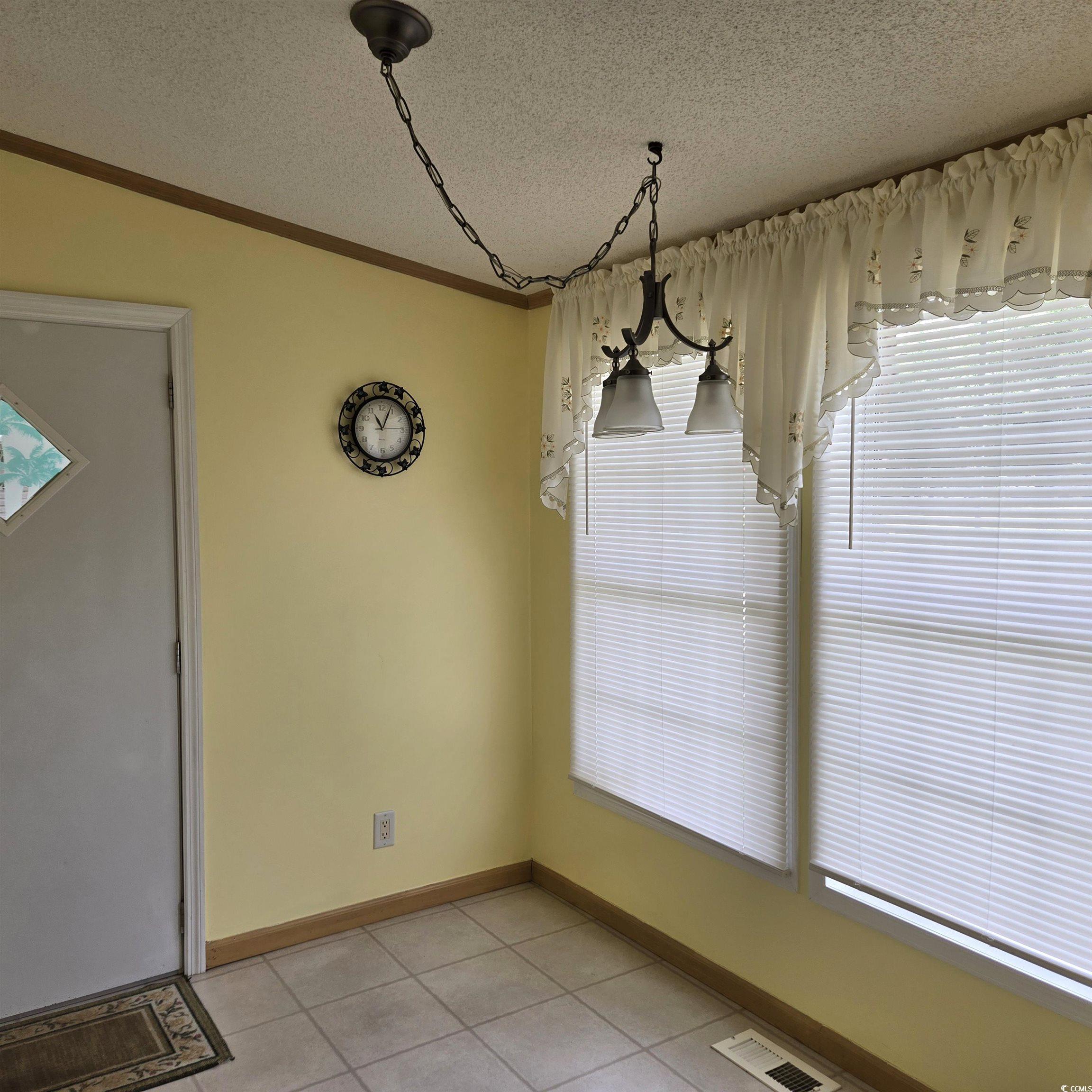 34 Talon Circle Murrells Inlet, SC 29576 - Photo 19 of 40 Breakfast Nook featuring light tile patterned flooring, a textured ceiling, and ornamental molding