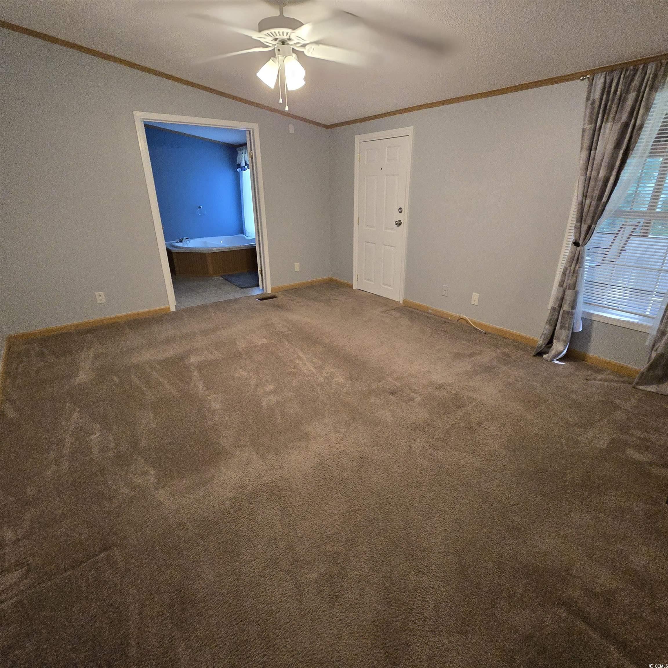 34 Talon Circle Murrells Inlet, SC 29576 - Photo 22 of 40 Master Bedroom with crown molding, a ceiling fan, carpet floors, and a textured ceiling