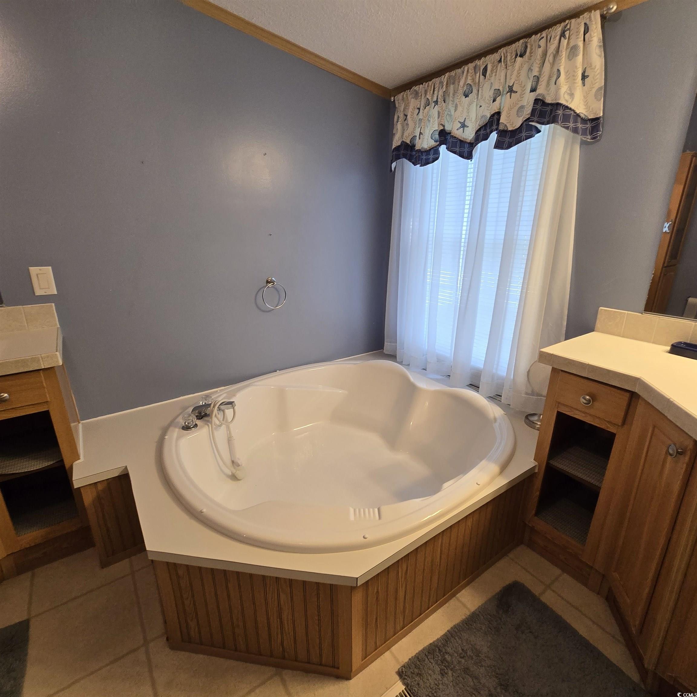 34 Talon Circle Murrells Inlet, SC 29576 - Photo 24 of 40 Full bathroom with a garden tub, a textured ceiling, vanity, tile patterned flooring, and crown molding