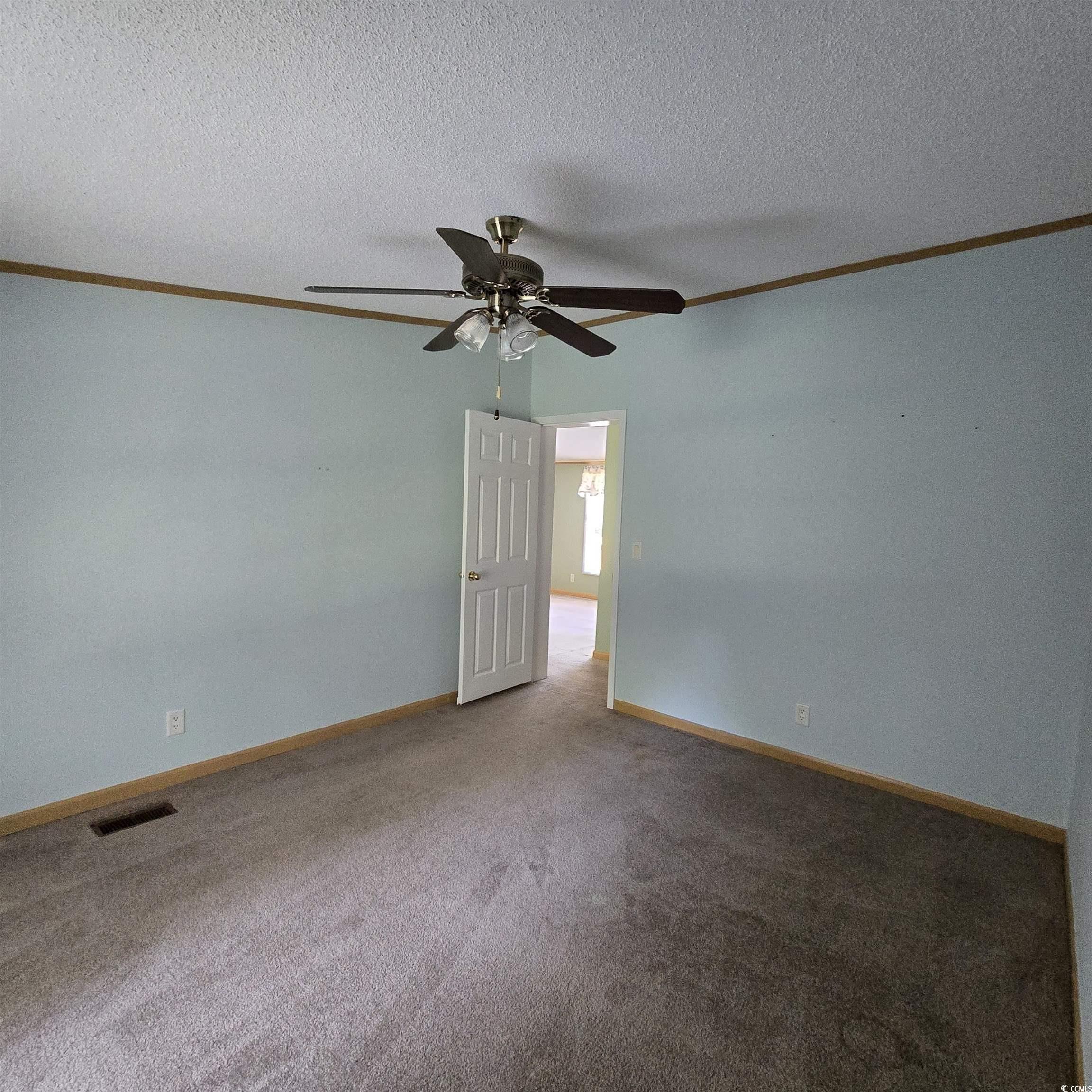 34 Talon Circle Murrells Inlet, SC 29576 - Photo 27 of 40 Carpeted spare room with ceiling fan, ornamental molding, and a textured ceiling