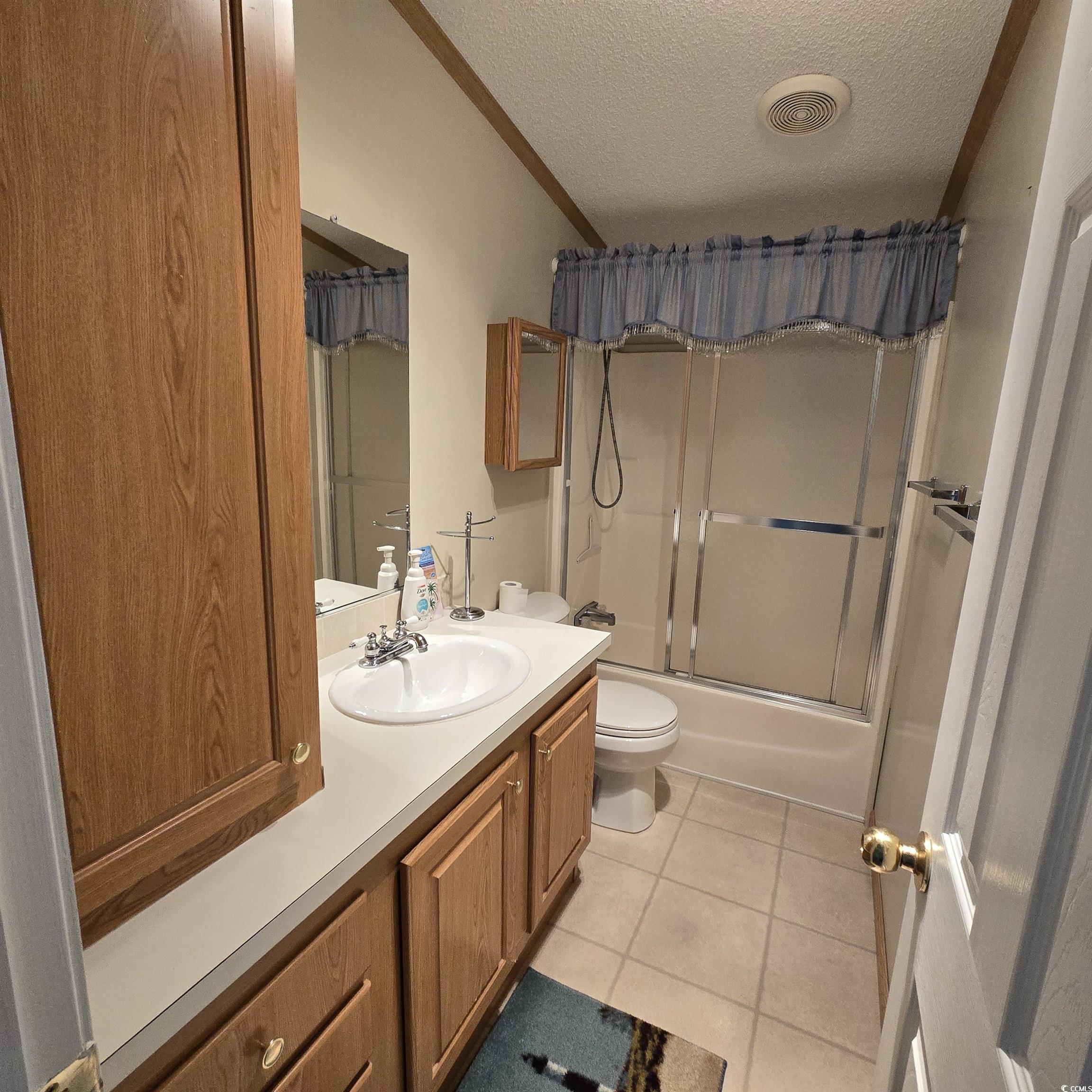 34 Talon Circle Murrells Inlet, SC 29576 - Photo 30 of 40 Full bathroom with tile patterned flooring, a textured ceiling, vanity, bath / shower combo with glass door, and crown molding