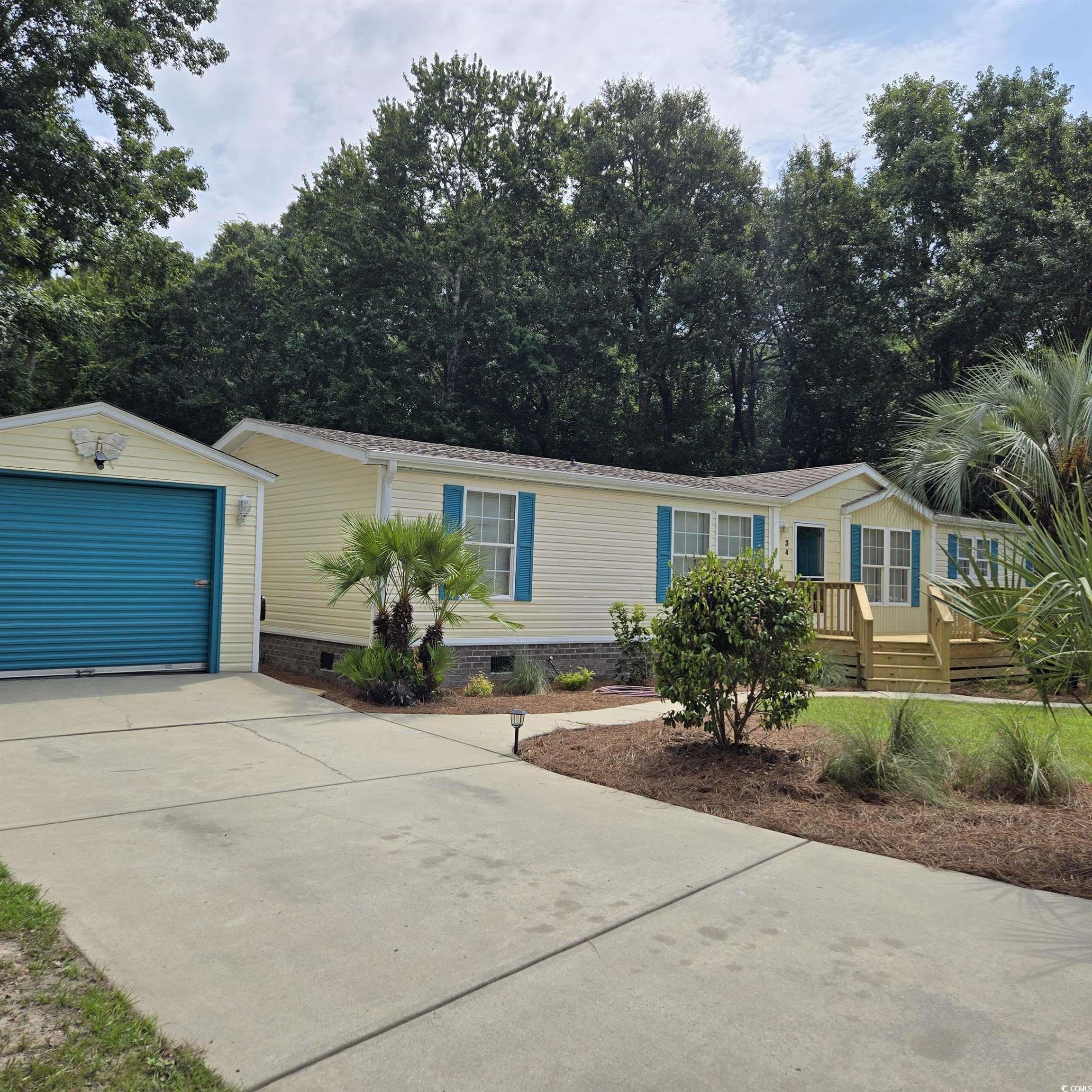 34 Talon Circle Murrells Inlet, SC 29576 - Photo 3 of 40 Manufactured / mobile home with driveway, an outbuilding, a detached garage, and crawl space