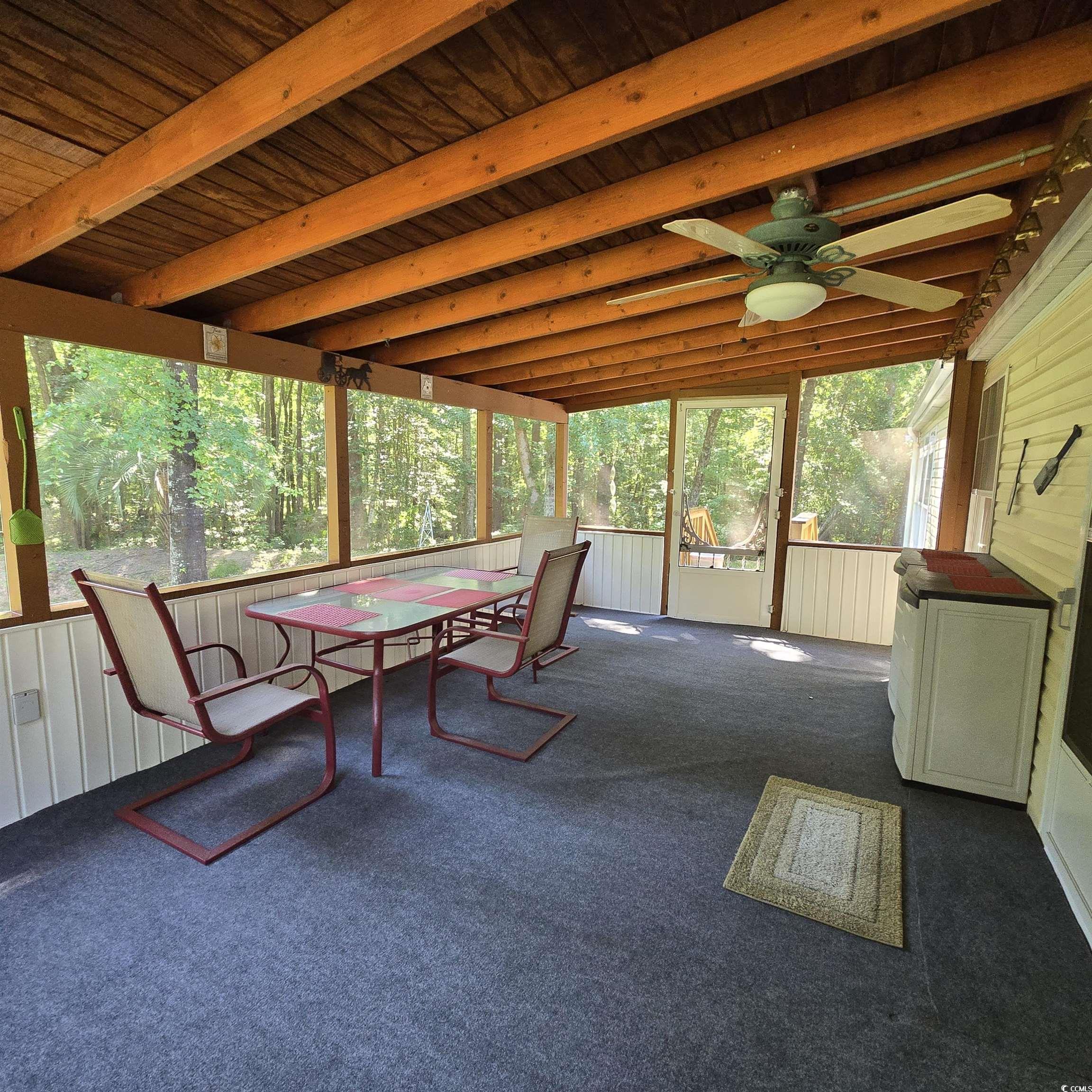 34 Talon Circle Murrells Inlet, SC 29576 - Photo 33 of 40 Sunroom / solarium with outdoor dining space, ceiling fan, and beam ceiling