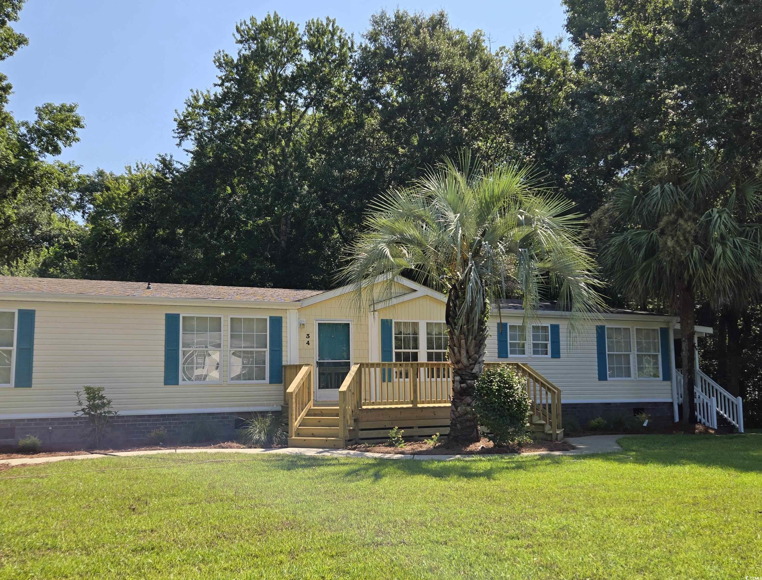 34 Talon Circle Murrells Inlet, SC 29576 - Photo 4 of 40 Manufactured / mobile home with crawl space, a front yard, a wooden deck, and stairway