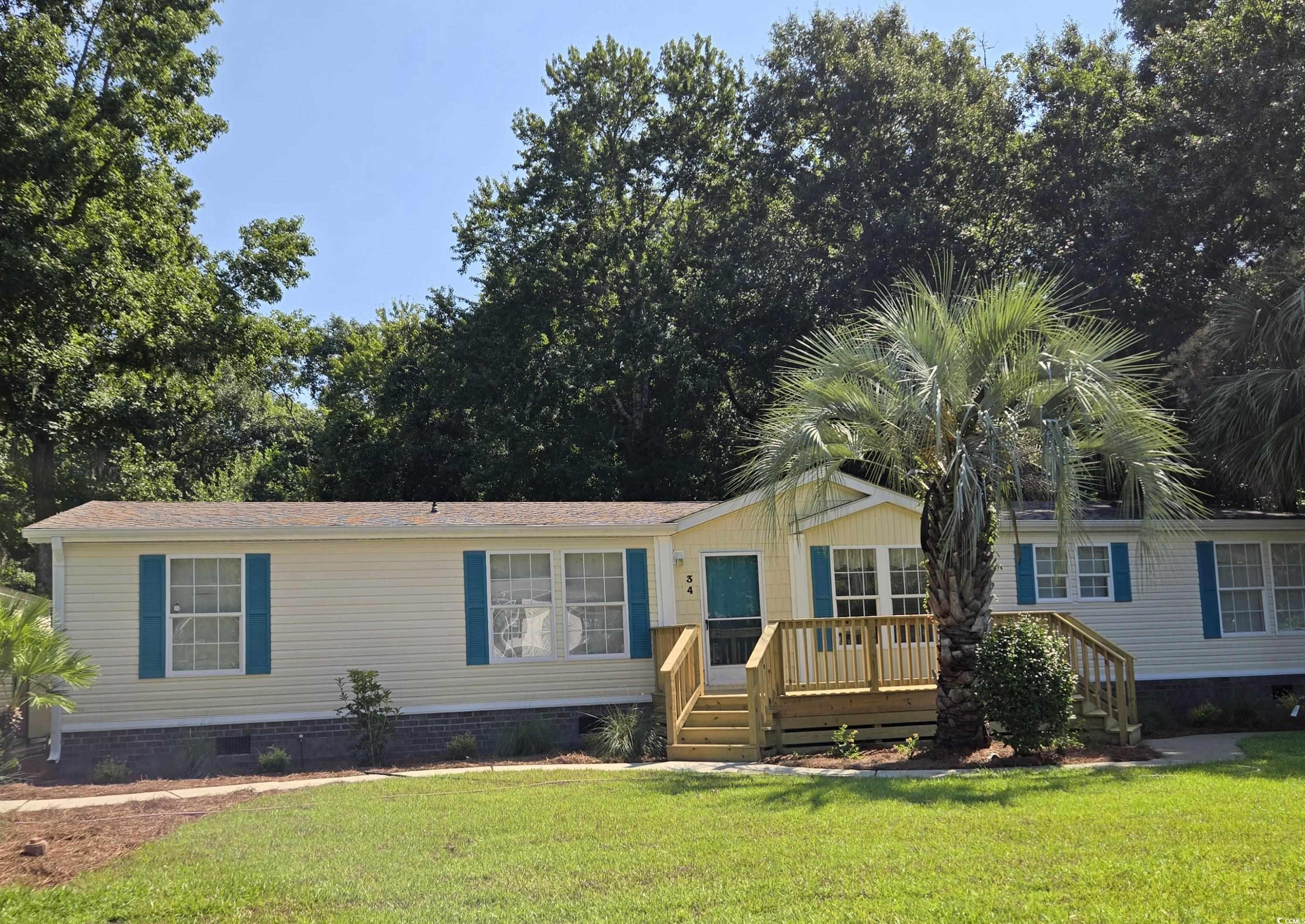 34 Talon Circle Murrells Inlet, SC 29576 - Photo 5 of 40 Manufactured / mobile home featuring crawl space, a wooden deck, and a front lawn