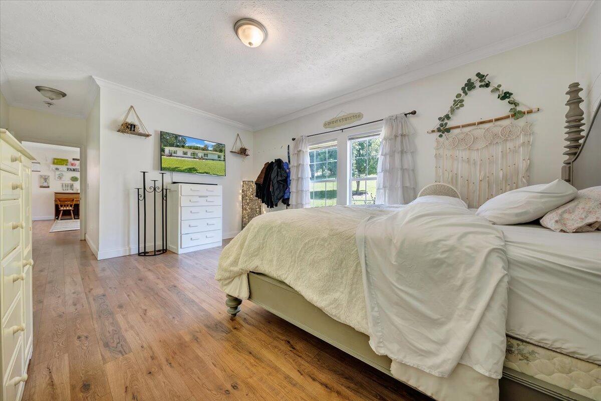 4315 Bandy Road Roanoke, VA 24014 - Photo 18 of 31 a bed sitting in a spacious bedroom next to a window and a flat screen tv