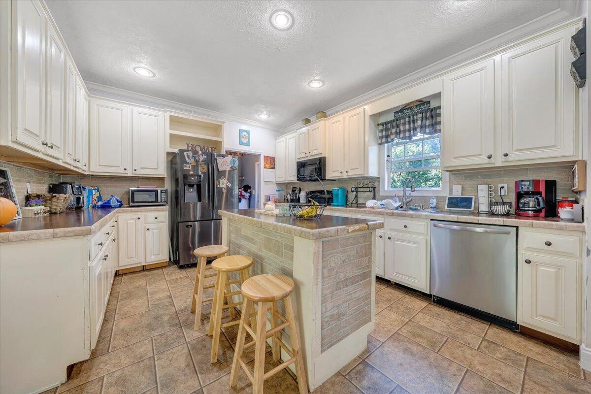 4315 Bandy Road Roanoke, VA 24014 - Photo 10 of 31 a kitchen with stainless steel appliances granite countertop a refrigerator sink and cabinets
