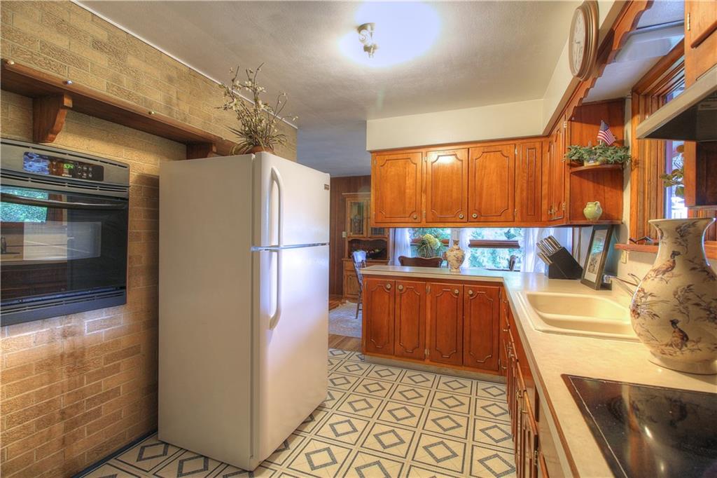 306 Brewer Road Rochester, PA 15074 - Photo 7 of 25 Ample space for cooking in the kitchen with the wall oven and glass electric cook-top.