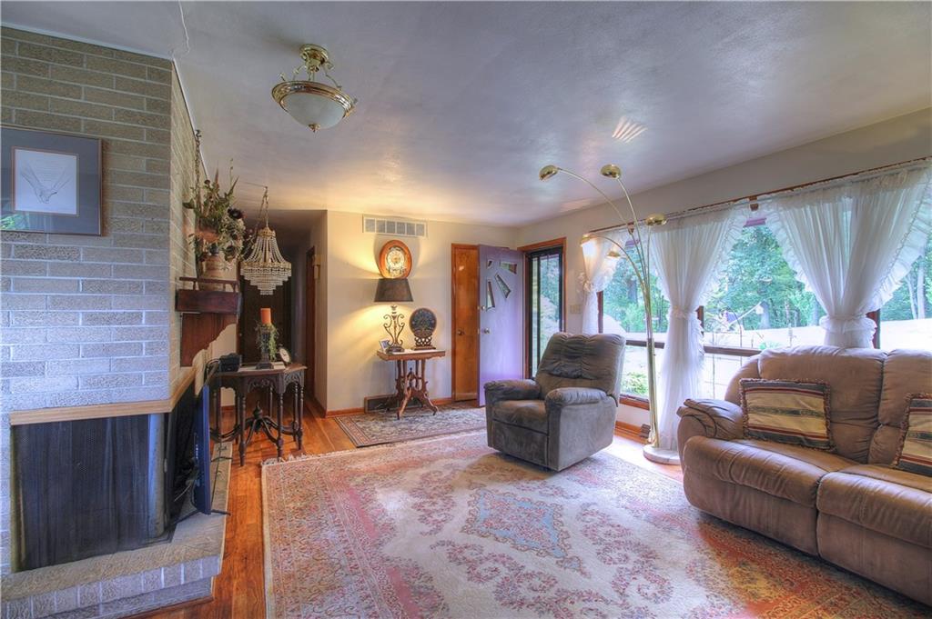 306 Brewer Road Rochester, PA 15074 - Photo 8 of 25 Enjoy the wood burning fireplace that wraps into the dining room.