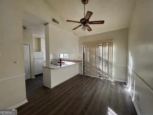 a kitchen with a sink stove and refrigerator