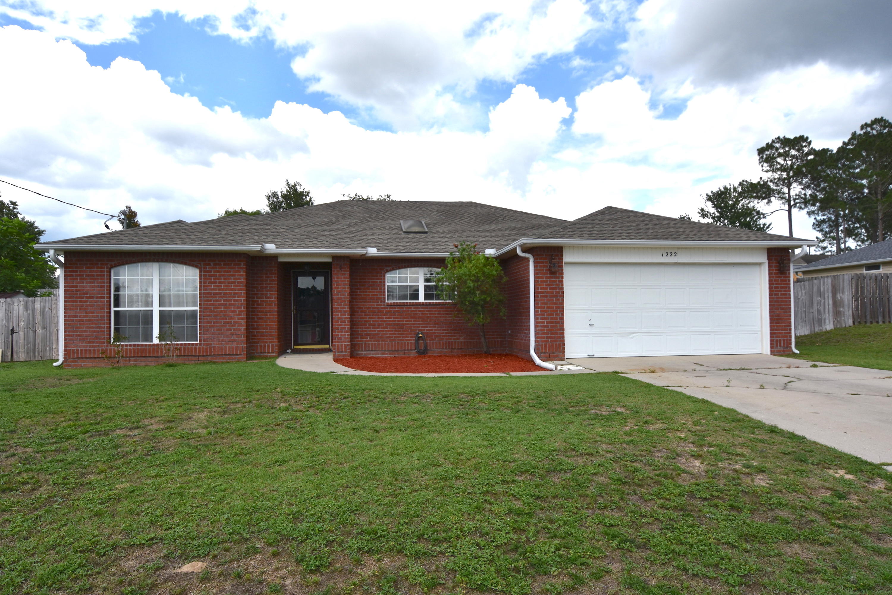 1222 Northview Drive Crestview, FL 32536 - Photo 1 of 36 a front view of a house with a garden and yard