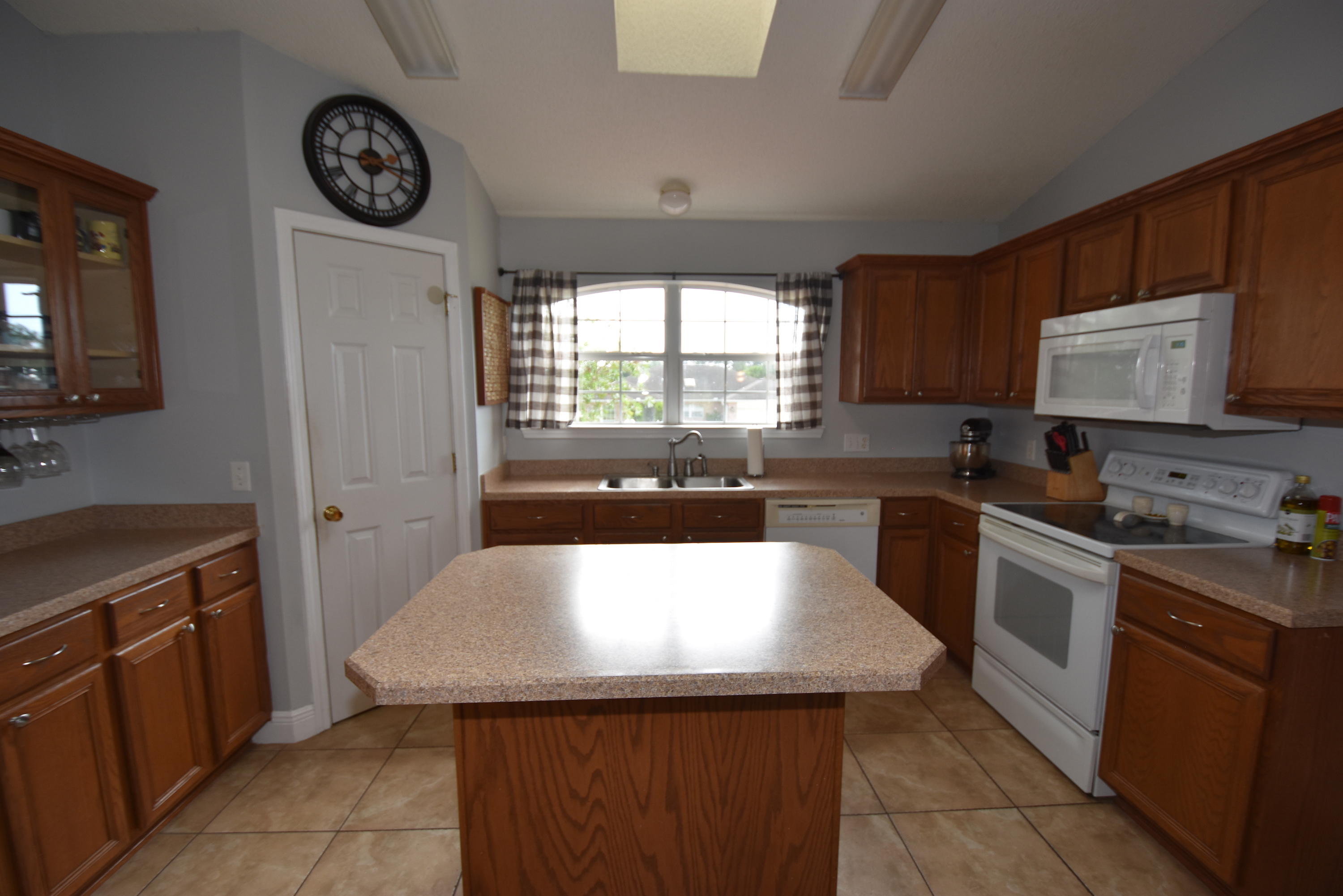 1222 Northview Drive Crestview, FL 32536 - Photo 15 of 36 a kitchen with a stove a sink and a refrigerator