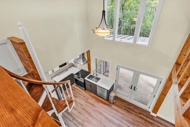 a view of a room with wooden floor and windows
