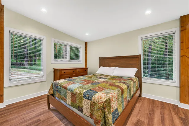 a bedroom with a bed and a large window
