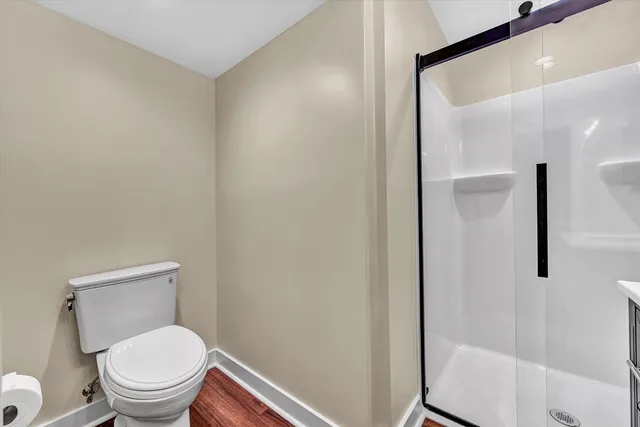 a white toilet sitting next to a bathroom sink