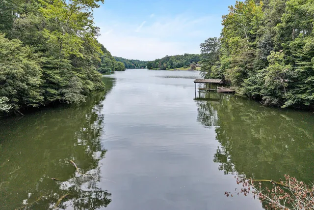 a backyard of a house with a garden and outdoor seating