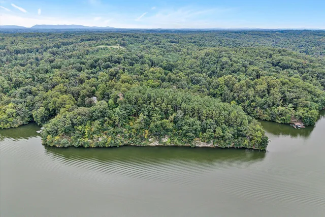 a view of a lake with a table and chairs