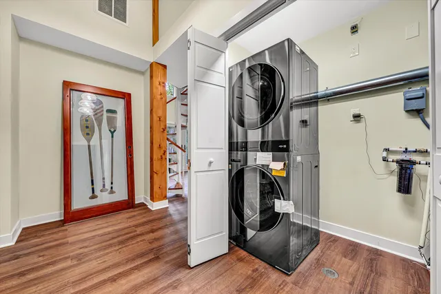 a view of a hallway with wooden floor and staircase