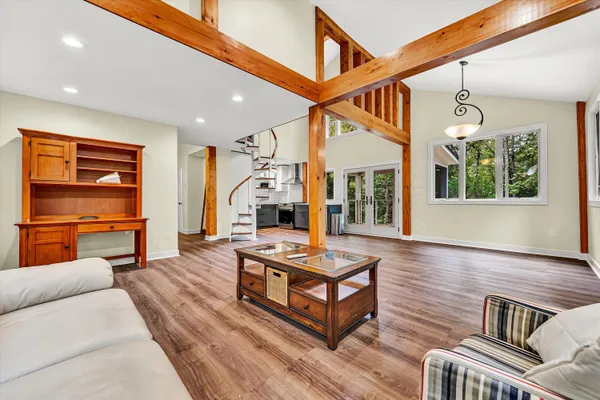 a living room with furniture a ceiling fan and a window
