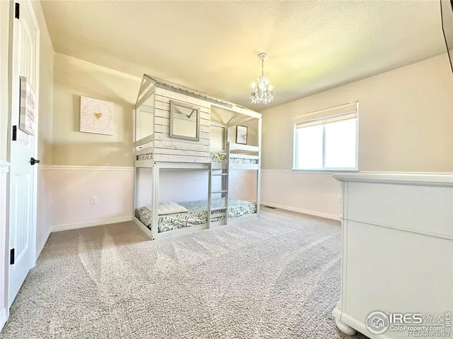 a bathroom with a granite countertop bathtub sink double vanity and mirror