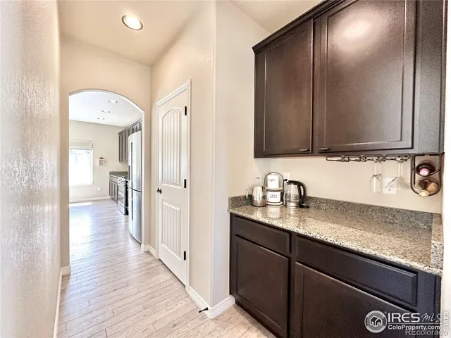 a living room with stainless steel appliances kitchen island granite countertop furniture a rug and a kitchen view