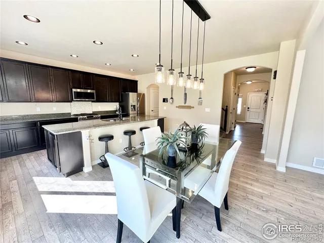 a kitchen with counter top space and wooden floor