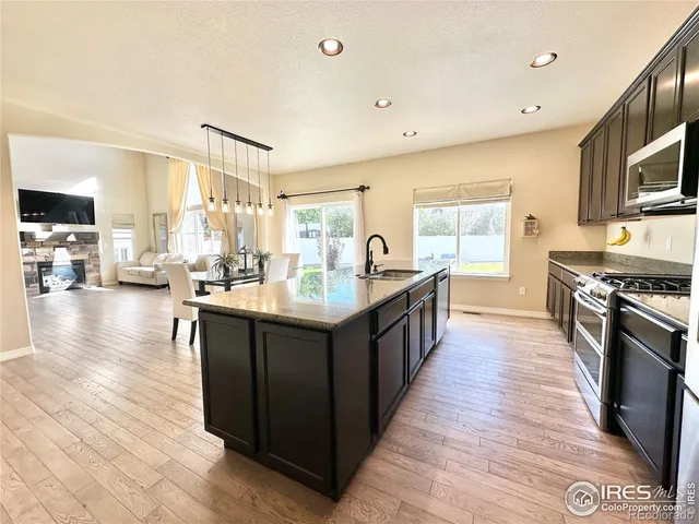 a large kitchen with a table and chairs